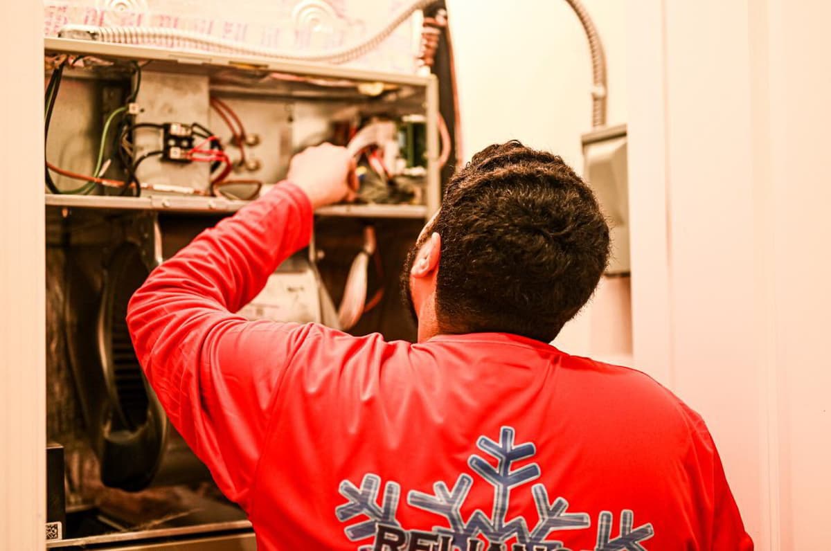 Reliance technician servicing an indoor air handler